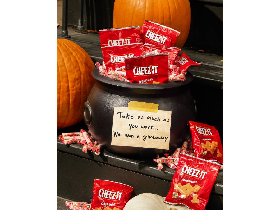 Cauldron Filled with cheez-its and candy with a note on the front that says take as many as you want we won a giveaway