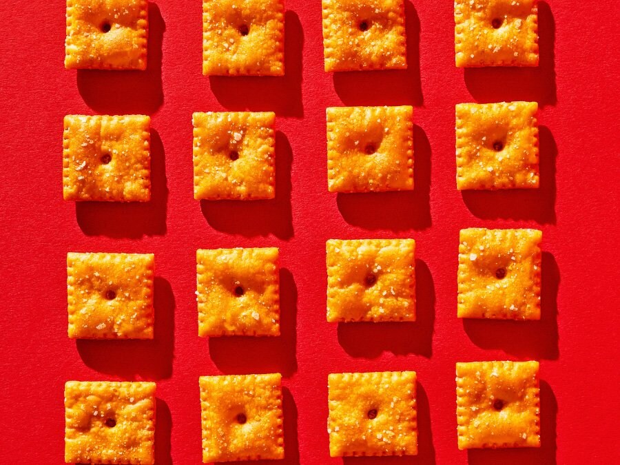 A grid of Cheez-it crackers on a red background